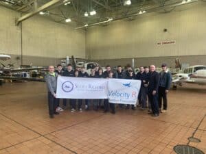 Students at BAVTS Visit to Scott Richards Aviation with VelocityR Aviation - holding sign - 2